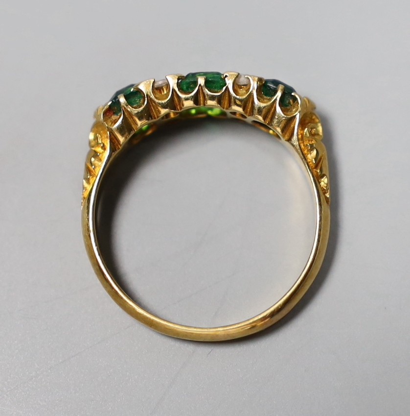 An Edwardian 18ct gold, thee stone green doublet and rose cut diamond chip set half hoop ring, size O, gross 4 grams.
